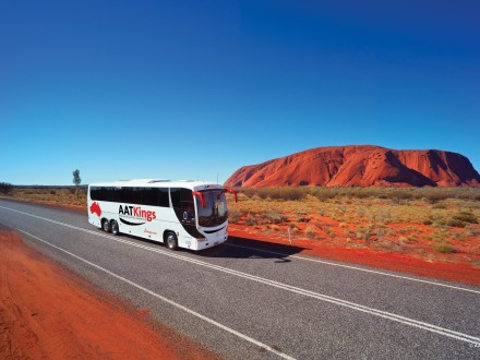 AATKings coach in from of Uluru