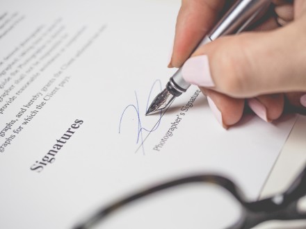 close-up view of fountain pen being used to sign a document