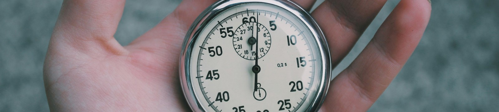 Hand holding old pocket watch