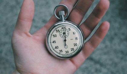 Hand holding old pocket watch